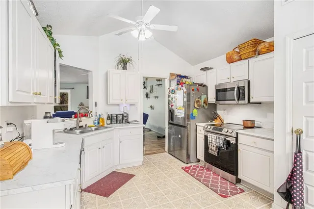 a kitchen with cabinets and window