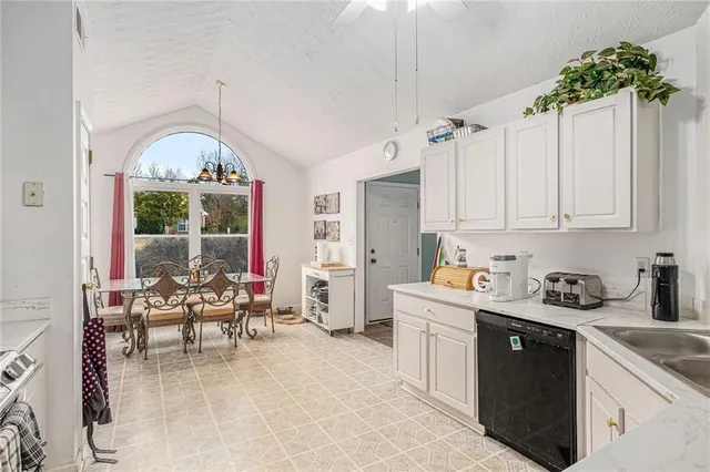 a bedroom with a bed a flat screen tv and a dresser