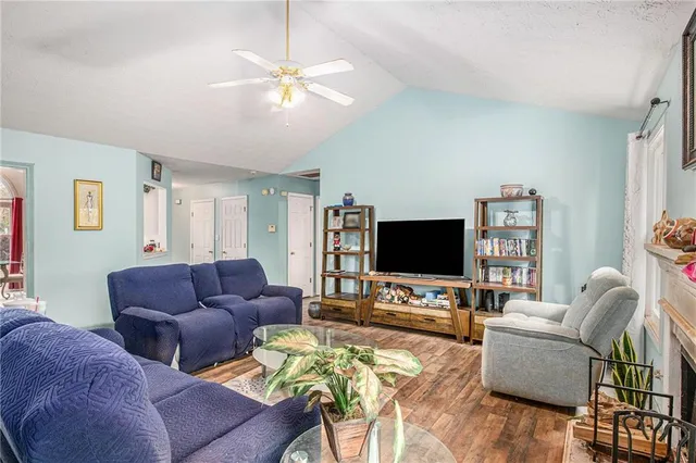 a living room with furniture a fireplace and a flat screen tv
