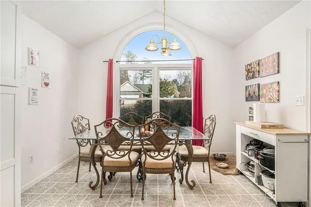 a dining room with furniture and a window