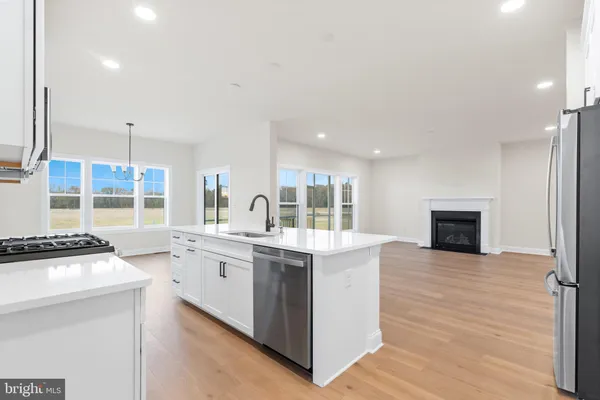 a large kitchen with a stove and a sink