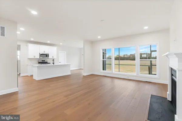 a view of kitchen with wooden floor and windows