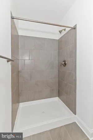 a bathroom with a shower and a bath tub