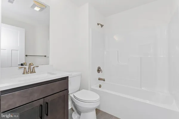 a bathroom with a sink a toilet and a bathtub
