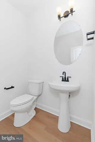 a white toilet sitting next to a bathroom sink