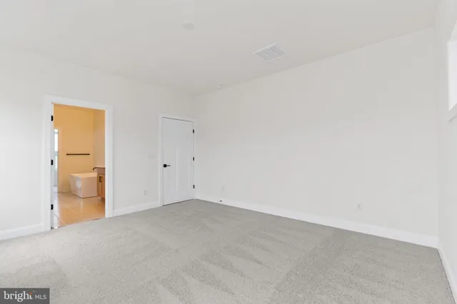 an empty room with closet and bathroom