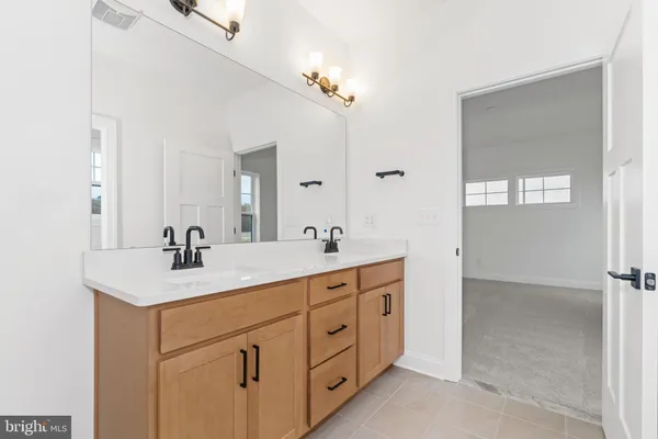 a bathroom with a sink a light fixture a vanity and a mirror