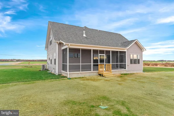 a view of a house with a yard and sitting area