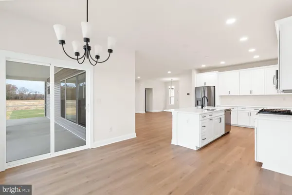 a large kitchen with a large counter top appliances and cabinets