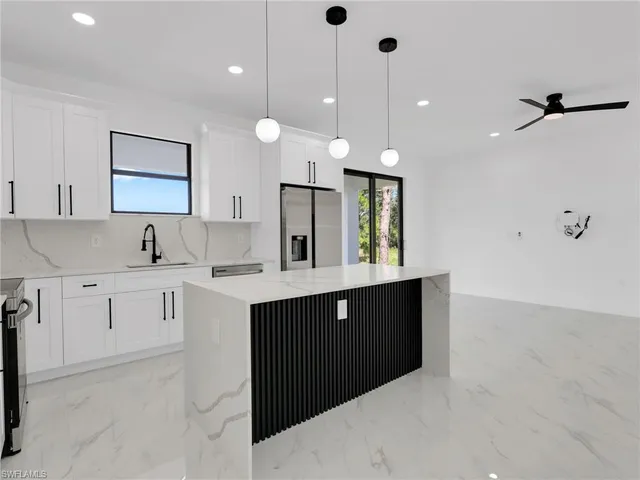 a large kitchen with cabinets and stainless steel appliances