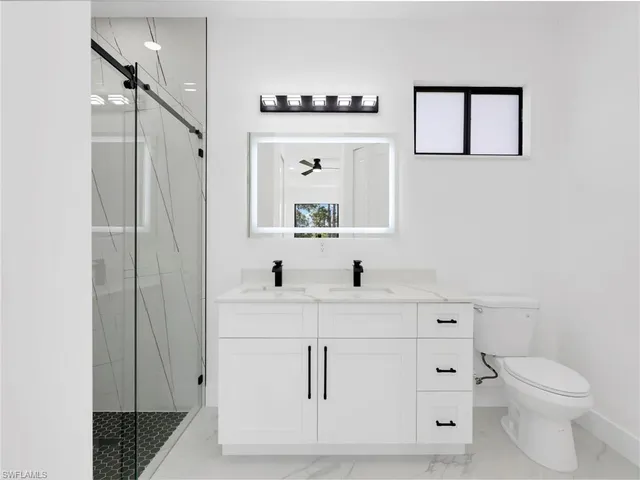 a bathroom with a sink a toilet and mirror