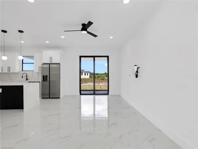 a view of a kitchen with a sink and refrigerator