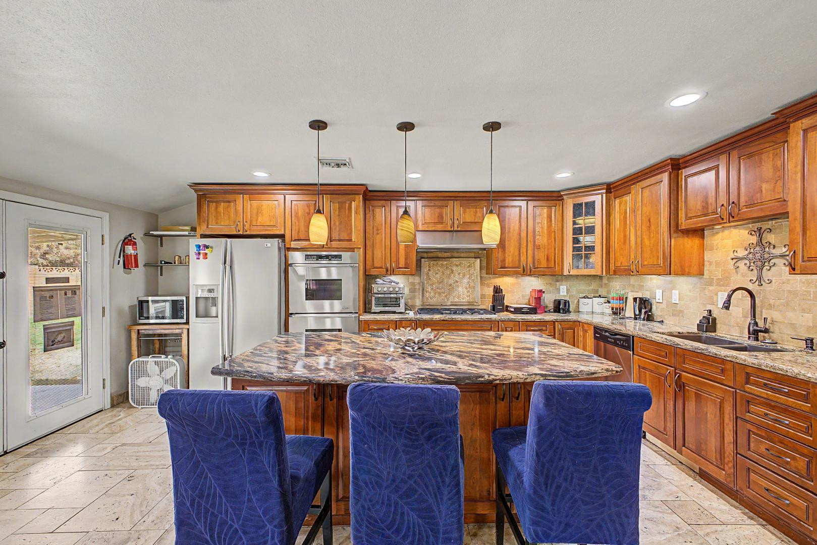 3346 East Cochise Road Phoenix, AZ 85028 - Photo 13 of 40 a kitchen with stainless steel appliances granite countertop a sink and a refrigerator