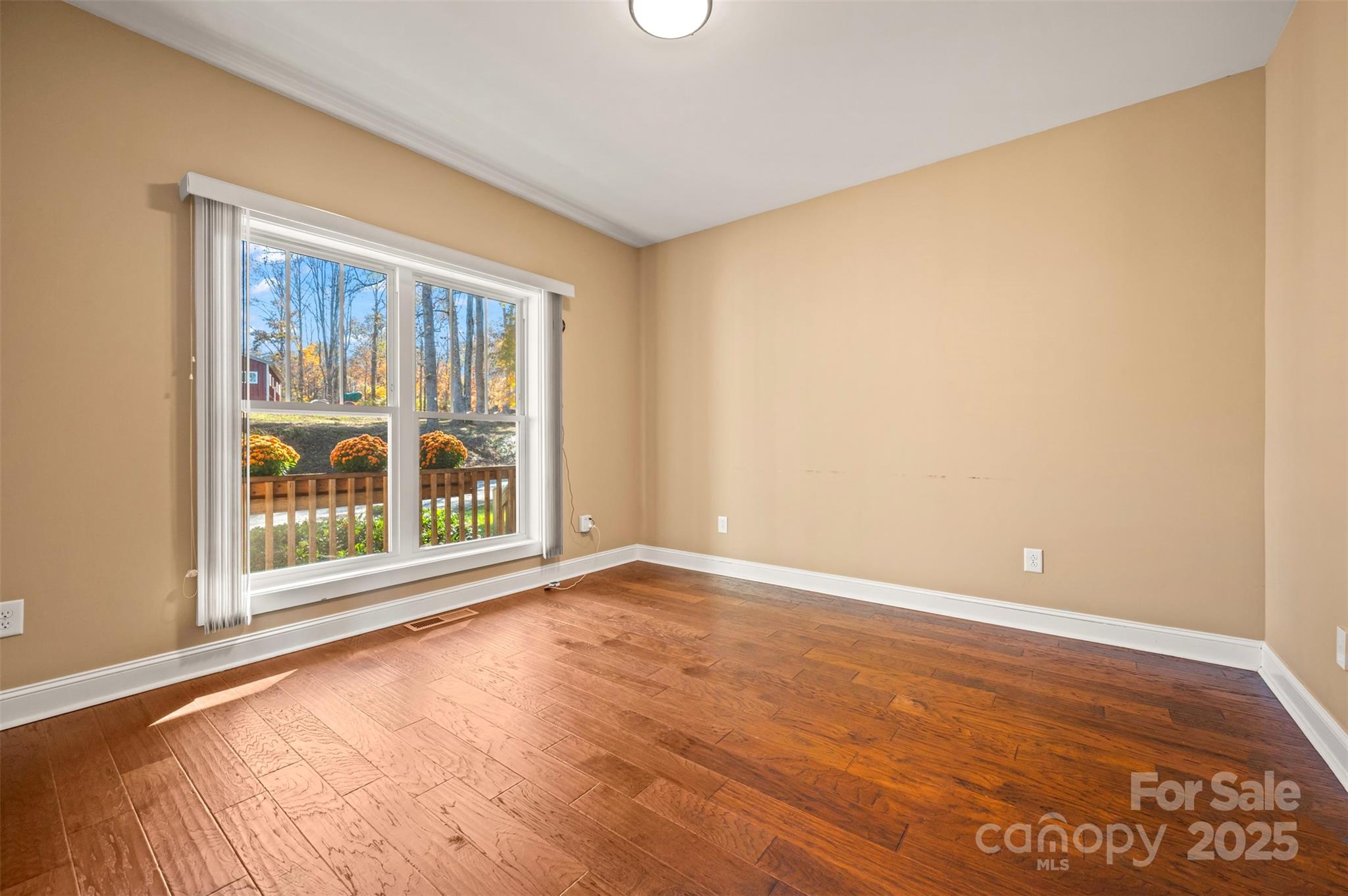 10105 Highway 108 Mill Spring, NC 28756 - Photo 12 of 44 an empty room with wooden floor and windows