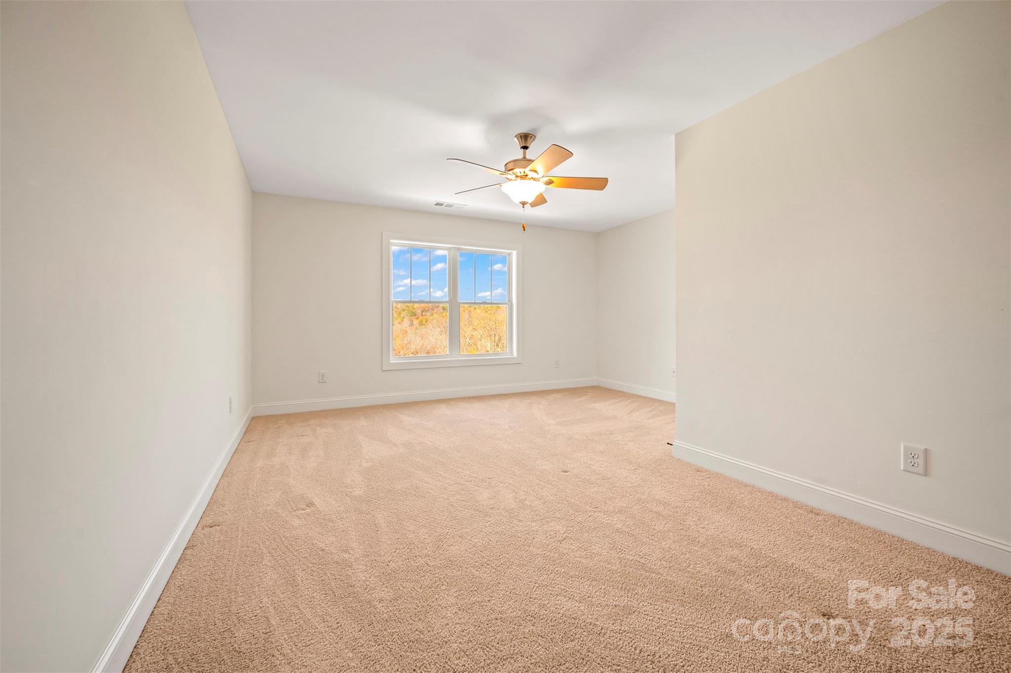 10105 Highway 108 Mill Spring, NC 28756 - Photo 23 of 44 an empty room with a window and a ceiling fan