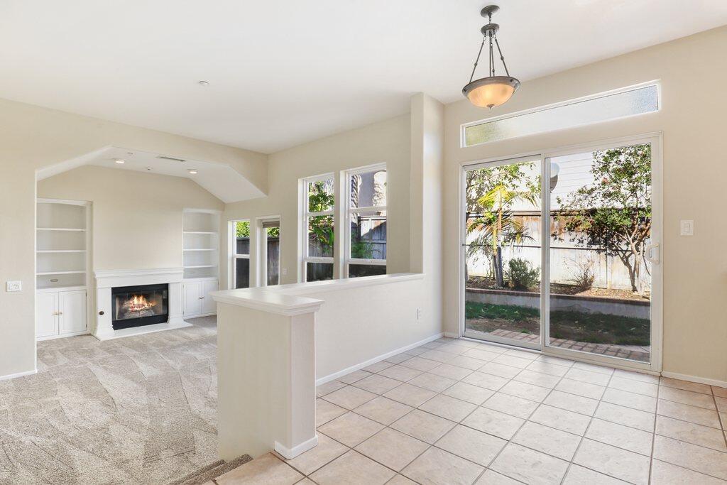 4695 Ellington Street Ventura, CA 93003 - Photo 11 of 43 a living room with a fireplace and a floor to ceiling window