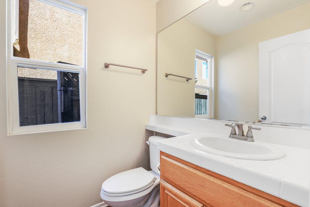 4695 Ellington Street Ventura, CA 93003 - Photo 22 of 43 a bathroom with a sink a toilet and a mirror