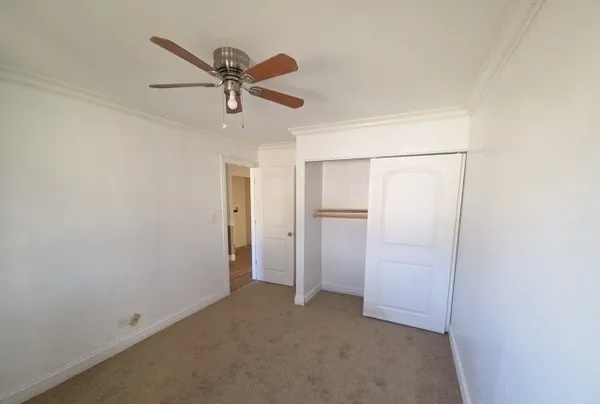 an empty room with closet and entryway