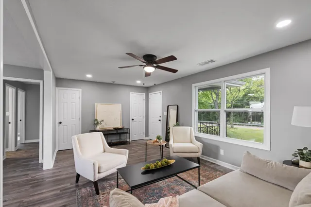 a living room with furniture and a large window