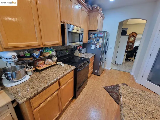 a kitchen with sink stove and cabinets