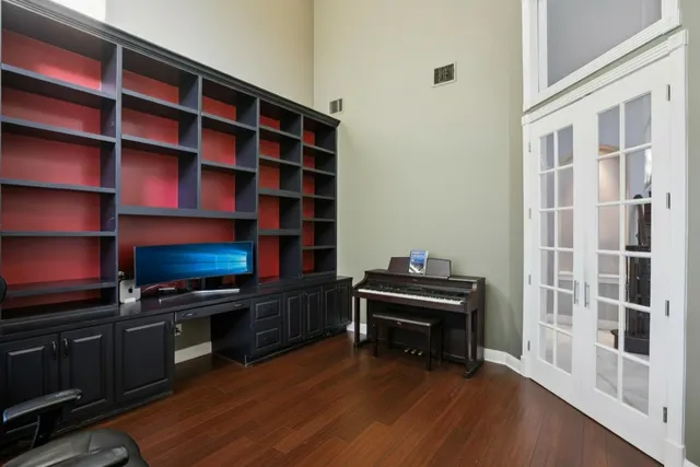 a view of a workspace with furniture and wooden floor