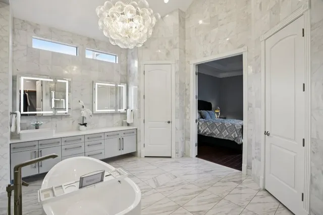 a spacious bathroom with a sink a large mirror and vanity