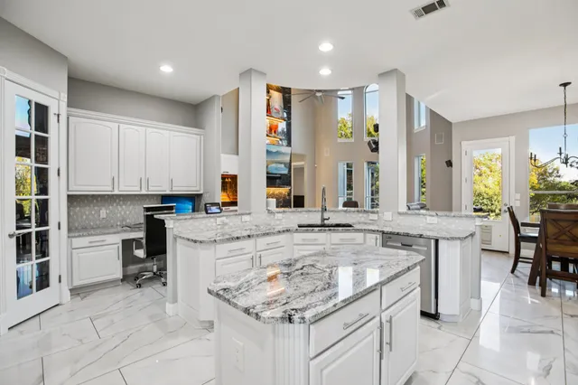 a kitchen with stainless steel appliances granite countertop a sink and cabinets