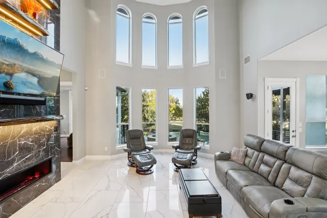 a living room with furniture fireplace and flat screen tv