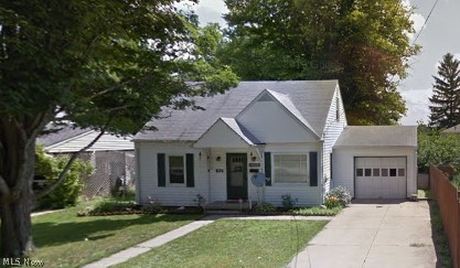 406 Terrace Street Rittman, OH 44270 - Photo 1 of 1 View of front facade featuring a garage and a front lawn