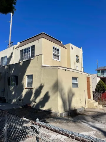 a kitchen with granite countertop white cabinets and black appliances