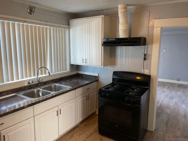 a view of a room with wooden floor