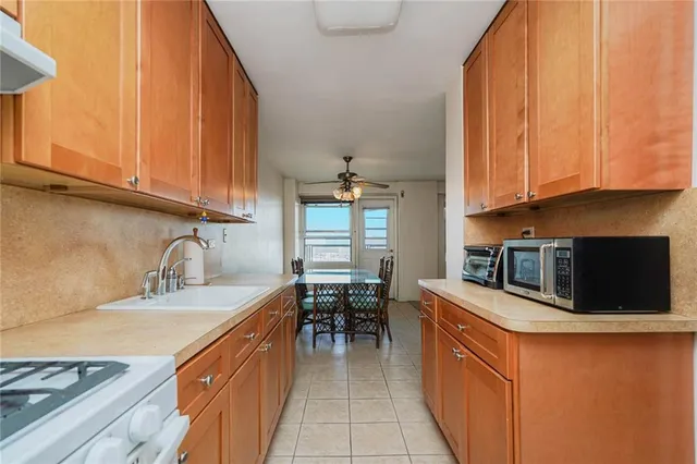 a kitchen with a sink stove and cabinets