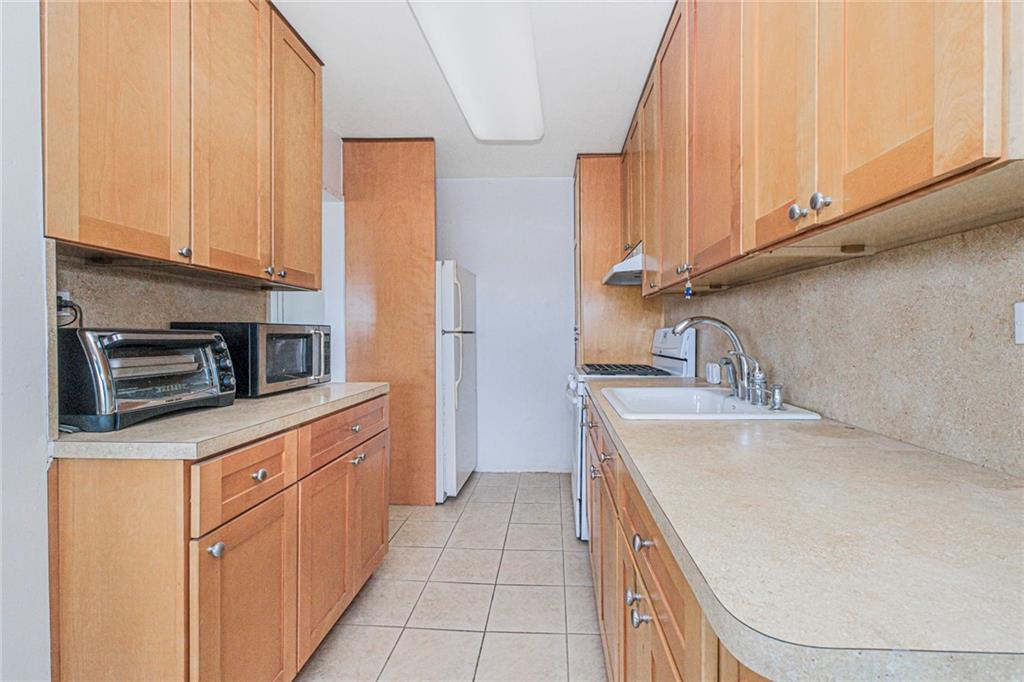 2630 Cropsey Avenue, Unit 9B Brooklyn, NY 11214 - Photo 18 of 29 a kitchen with stainless steel appliances granite countertop a sink and a stove