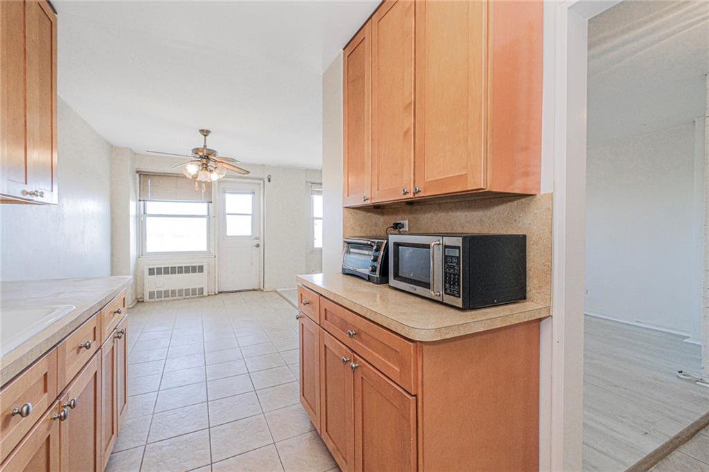 2630 Cropsey Avenue, Unit 9B Brooklyn, NY 11214 - Photo 20 of 29 a kitchen with a stove and a microwave