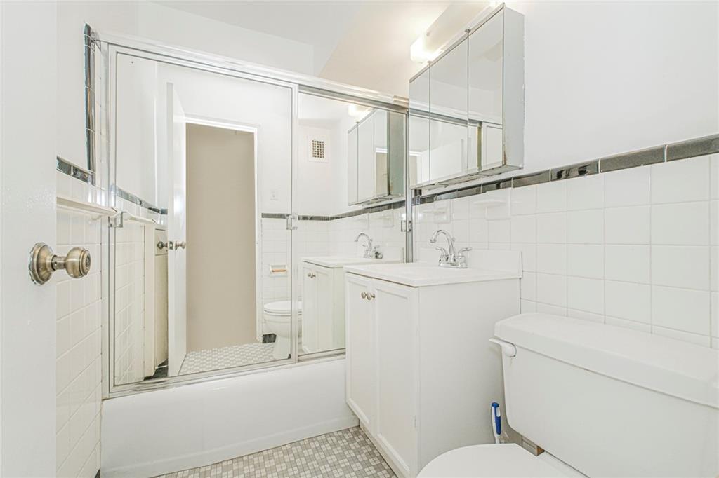 2630 Cropsey Avenue, Unit 9B Brooklyn, NY 11214 - Photo 26 of 29 a bathroom with a sink a toilet and shower