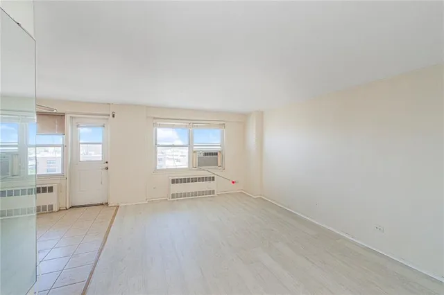 a view of a big room with windows and cabinet
