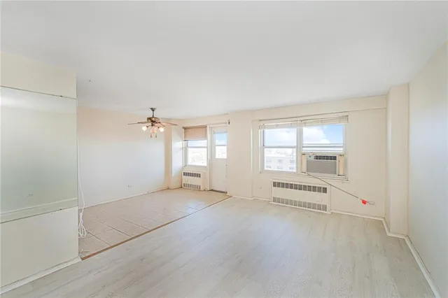 an empty room with windows and pillars in it