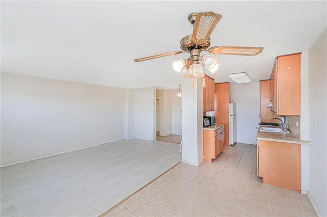 a view of a kitchen with a sink and a refrigerator