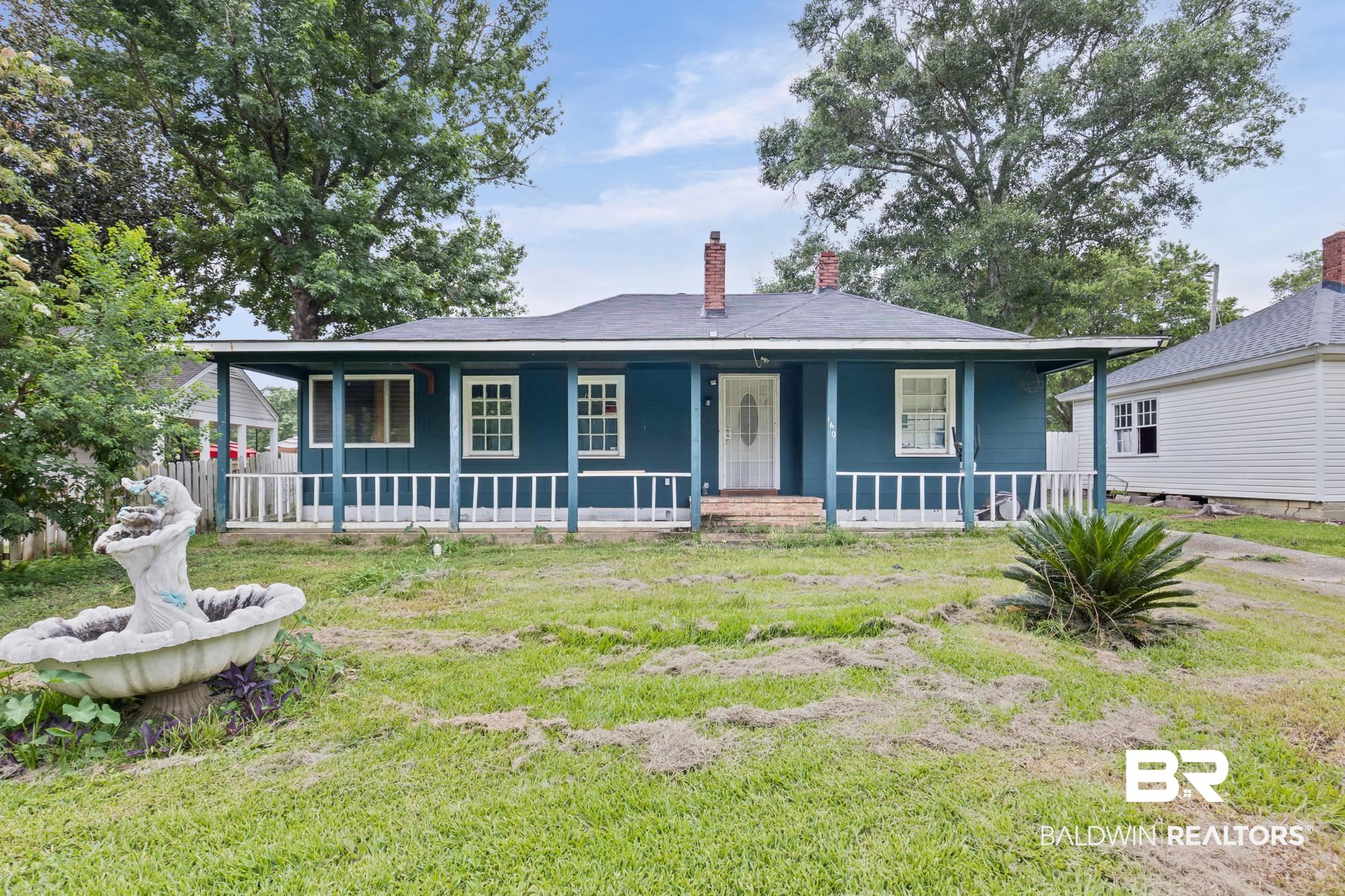 160 Glenn Avenue Mobile, AL 36606 - Photo 1 of 15 Ranch-style residence featuring a covered front porch with white railing, a dark blue exterior, and white-framed windows
