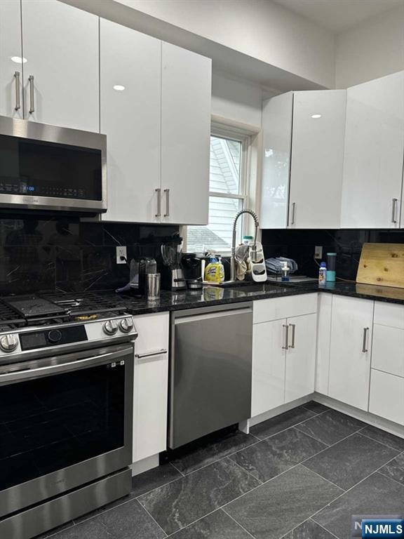 194 Washington Avenue, Unit 1 Rutherford, NJ 07070 - Photo 24 of 29 a kitchen with a stove and white cabinets