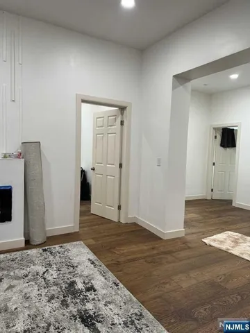 an empty room with wooden floor and a window