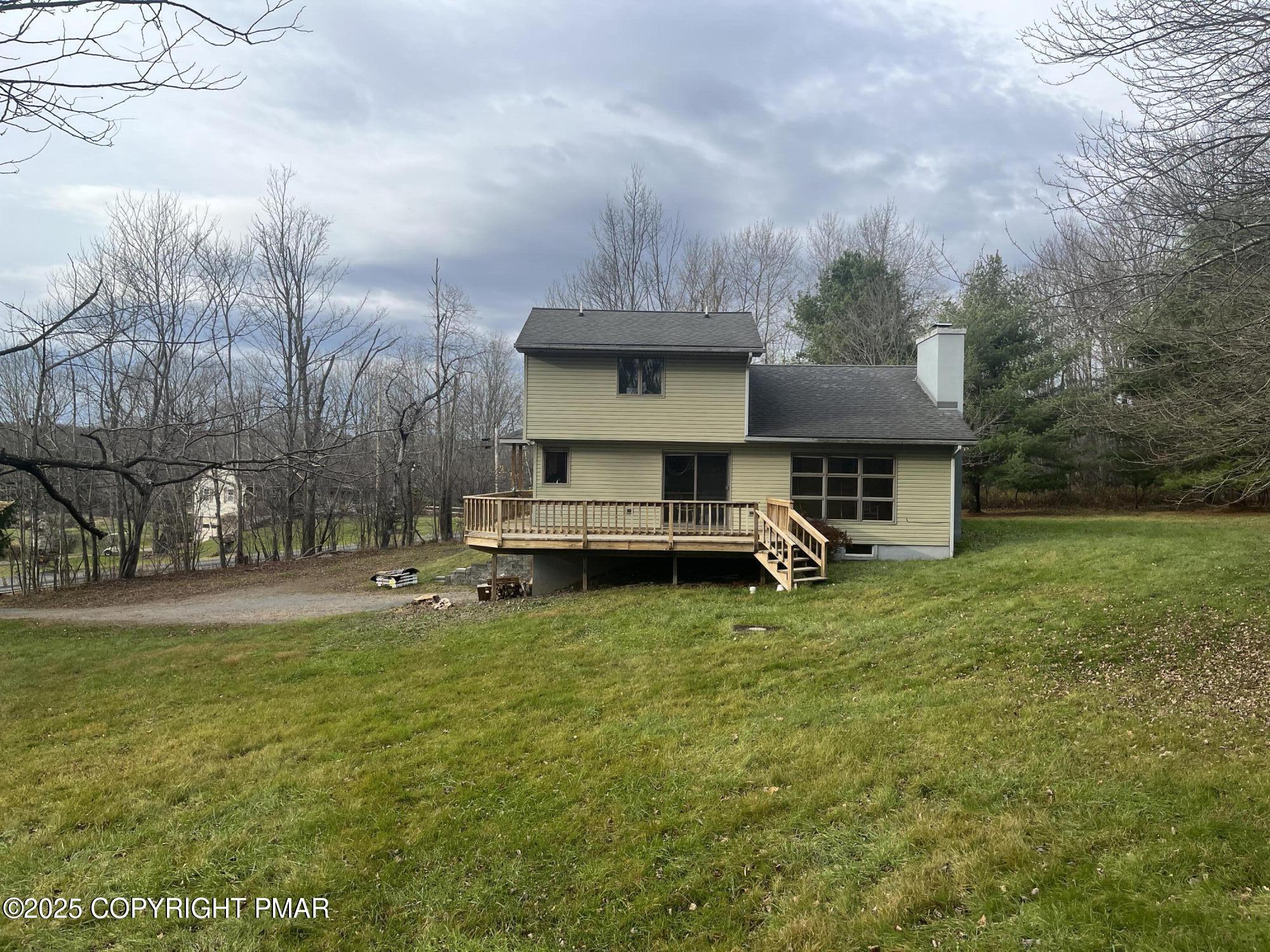 a view of a house with a yard and sitting area