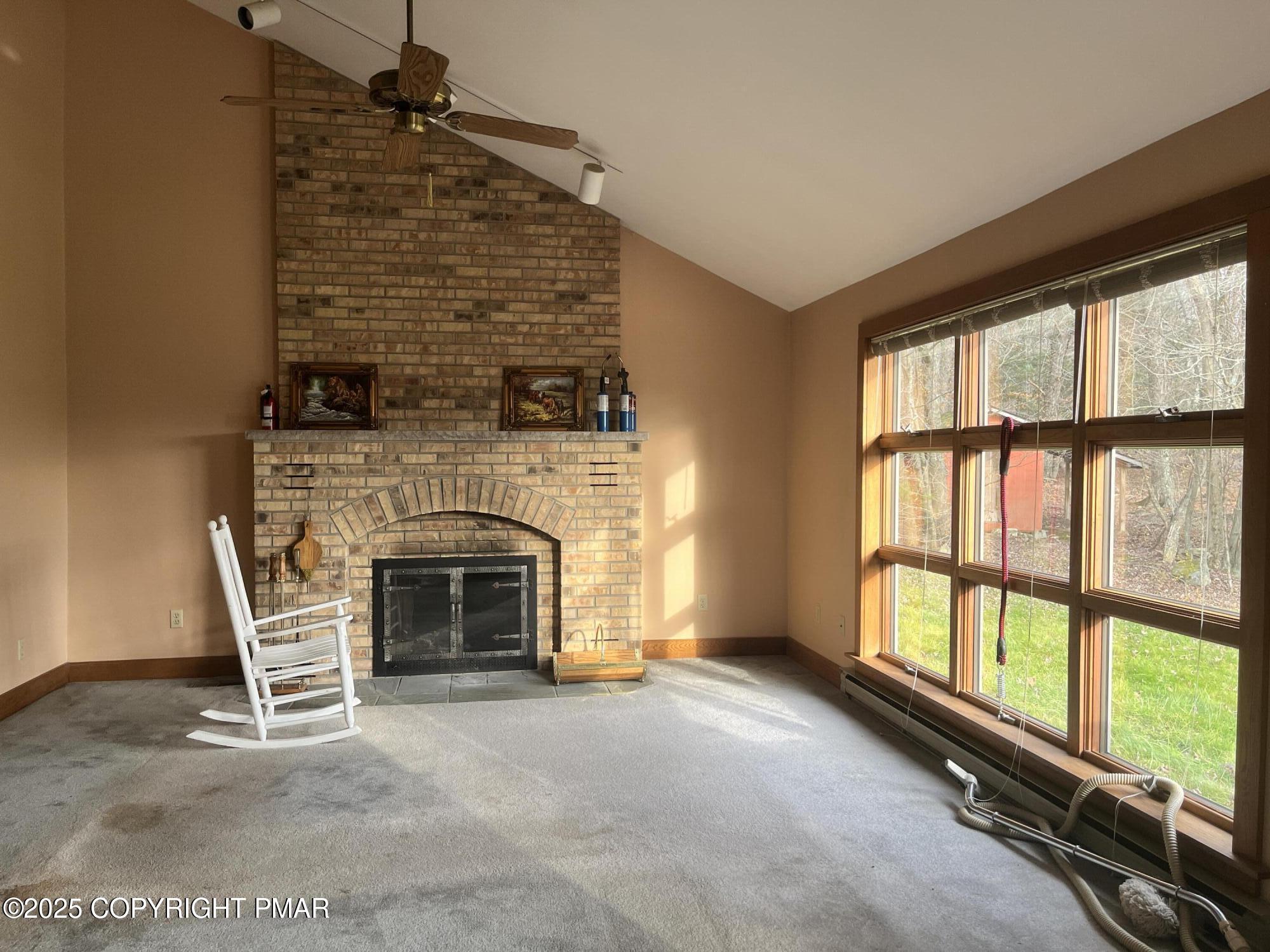 1970 Aberdeen Road Moscow, PA 18444 - Photo 17 of 45 a living room with a fireplace and a floor to ceiling window