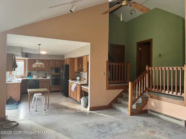 a kitchen with stainless steel appliances granite countertop a refrigerator stove and sink