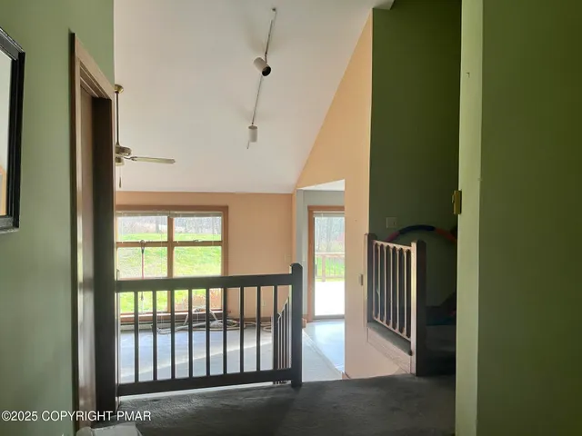 a view of a hallway with entryway door