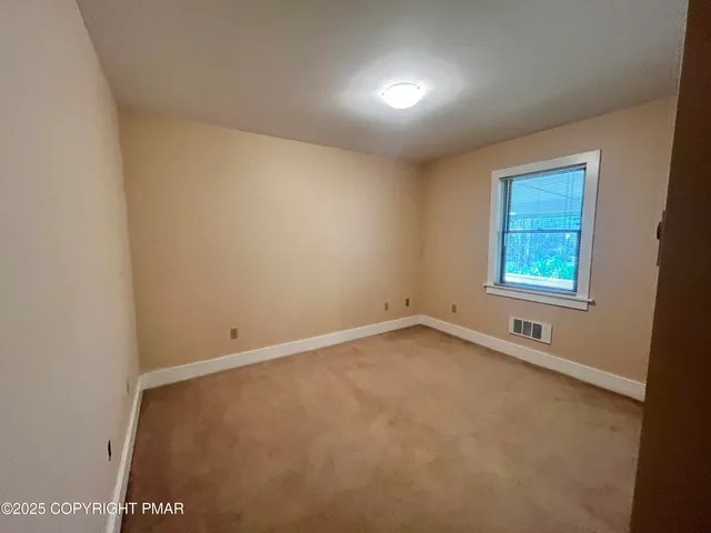 an empty room with a bench