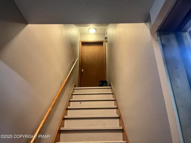 a view of a livingroom with wooden floor and a window