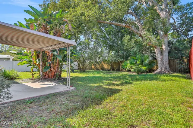 a view of a house with a yard and sitting area