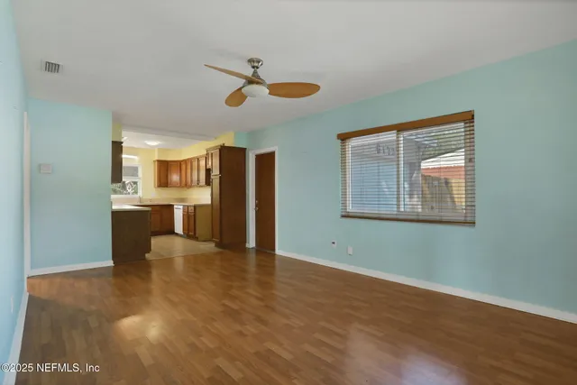 a view of a kitchen with a dishwasher cabinets and wooden floor