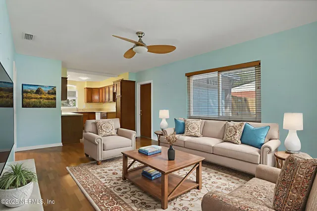 a living room with furniture ceiling fan and a rug
